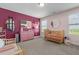 Colorful Bedroom with crib, pink dresser, and plenty of natural light at 784 Cypress Rd, Cameron, NC 28326