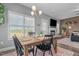 Bright dining area with natural light and a view to a fireplace through the door at 784 Cypress Rd, Cameron, NC 28326