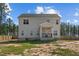 Back exterior view of a two-story home featuring a covered porch and vinyl siding at 784 Cypress Rd, Cameron, NC 28326