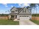 Charming two-story home with a well-manicured lawn and attached two-car garage at 784 Cypress Rd, Cameron, NC 28326
