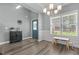 Bright foyer featuring lovely decor, neutral paint, a front door, and beautiful plank flooring at 784 Cypress Rd, Cameron, NC 28326