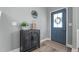 Stylish foyer featuring a modern black cabinet, lovely decor, and a welcoming front door at 784 Cypress Rd, Cameron, NC 28326