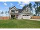 Inviting two-story home featuring a well-maintained lawn, a two-car garage, and a fenced-in backyard at 784 Cypress Rd, Cameron, NC 28326