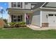 Inviting front porch with an American flag, beautiful landscaping and well-manicured lawn at 784 Cypress Rd, Cameron, NC 28326
