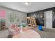 Fun playroom features climbing gym, pink rug and armchairs, and a chalkboard wall at 784 Cypress Rd, Cameron, NC 28326