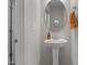 Elegant powder room with pedestal sink, stylish mirror and decor at 784 Cypress Rd, Cameron, NC 28326