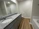 Bathroom with double sink granite vanity, tile floors, shower and soaking tub at 81 Coharie Dr, Lillington, NC 27546