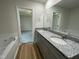 Bathroom with double sink granite vanity, soaking tub and tile floors at 81 Coharie Dr, Lillington, NC 27546