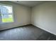 An empty bedroom with a window overlooking the lawn at 81 Coharie Dr, Lillington, NC 27546