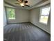 A well lit bedroom with trey ceilings, ceiling fan and plush carpeting at 81 Coharie Dr, Lillington, NC 27546