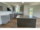 Stylish kitchen boasts granite counters, subway tile backsplash, modern appliances, and an island at 81 Coharie Dr, Lillington, NC 27546