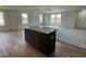 Open floor plan showcasing a kitchen with a center island and granite countertop at 81 Coharie Dr, Lillington, NC 27546