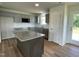 Well-lit kitchen features an island, modern cabinets, and stainless steel appliances at 81 Coharie Dr, Lillington, NC 27546
