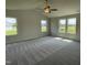 Bright living space with plush carpeting, vaulted ceiling and a ceiling fan for added comfort at 81 Coharie Dr, Lillington, NC 27546