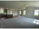 Spacious open concept area featuring plush carpet, stylish finishes and large windows overlooking green backyard at 81 Coharie Dr, Lillington, NC 27546