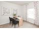 Bright home office space with wood desk, art, neutral paint, and a window with natural light at 837 Ottawa Dr, Garner, NC 27529