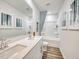 This bathroom features double sinks, white cabinets, and a shower and tub combo at 841 Ottawa Dr, Garner, NC 27529