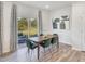 Dining room with a wooden table, six green chairs, modern artwork, and sliding glass doors to the patio at 841 Ottawa Dr, Garner, NC 27529
