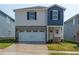 Charming two-story home featuring a two-car garage, landscaped yard, and a mix of vinyl siding and brick accents at 841 Ottawa Dr, Garner, NC 27529