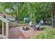 Backyard with patio area with outdoor furniture and view of the green backyard and shed at 847 E Maple Ln, Fuquay Varina, NC 27526