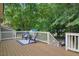 Backyard deck with outdoor furniture and view of green trees and backyard shed at 847 E Maple Ln, Fuquay Varina, NC 27526