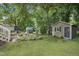 Charming backyard with a brick patio, a cozy shed, and lush green grass at 847 E Maple Ln, Fuquay Varina, NC 27526