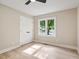 Bright bedroom with closet, large window, and hardwood floors at 847 E Maple Ln, Fuquay Varina, NC 27526