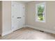 Bedroom with light hardwood flooring, window, and closet with double doors at 847 E Maple Ln, Fuquay Varina, NC 27526
