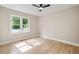 Sunny bedroom with ceiling fan and large window at 847 E Maple Ln, Fuquay Varina, NC 27526