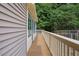 Side view of home with siding and long, wooden deck, overlooking green backyard at 847 E Maple Ln, Fuquay Varina, NC 27526