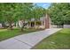 Charming home features a welcoming front porch, neutral siding, and a spacious driveway set on a beautifully landscaped lot at 847 E Maple Ln, Fuquay Varina, NC 27526