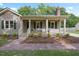 Charming one-story home featuring a welcoming front porch, neutral siding, and lush landscaping, set on a beautiful lot at 847 E Maple Ln, Fuquay Varina, NC 27526