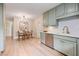Kitchen and dining area featuring stainless steel appliances and stylish cabinetry at 847 E Maple Ln, Fuquay Varina, NC 27526