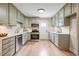 Stylish kitchen with stainless steel appliances, sleek countertops, and trendy sage-green cabinetry at 847 E Maple Ln, Fuquay Varina, NC 27526