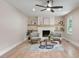 Bright living room with hardwood floors, ceiling fan, fireplace, built-in shelves, and natural light from a window at 847 E Maple Ln, Fuquay Varina, NC 27526