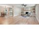 Open living room with hardwood floors adjacent to dining area features a fireplace, built-in shelves and natural light at 847 E Maple Ln, Fuquay Varina, NC 27526