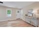Bright living room features hardwood floors, a light color palette, console table, and natural light from the window at 847 E Maple Ln, Fuquay Varina, NC 27526
