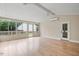 Bright sunroom featuring hardwood floors, ceiling fans, and access door to the outside at 847 E Maple Ln, Fuquay Varina, NC 27526