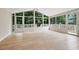 Bright sunroom featuring hardwood floors, ceiling fan, and glass windows leading to an outdoor deck at 847 E Maple Ln, Fuquay Varina, NC 27526