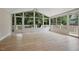 Bright sunroom featuring hardwood floors, ceiling fan, and glass windows leading to an outdoor deck at 847 E Maple Ln, Fuquay Varina, NC 27526