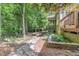Landscaped backyard with stone walkway leading to deck and screened porch at 850 N Langdon, Pittsboro, NC 27312