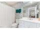 Bathroom with elegant wallpaper, white vanity, and shower-tub combo at 850 N Langdon, Pittsboro, NC 27312