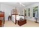 Bright bedroom features four-poster bed, neutral walls, and a ceiling fan for optimal comfort at 850 N Langdon, Pittsboro, NC 27312