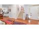 Bright entryway with hardwood floors, staircase, and a view into the adjacent kitchen and dining area at 850 N Langdon, Pittsboro, NC 27312