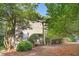 Two-story home with a charming front entrance and a well-maintained yard with mature landscaping and brick path at 850 N Langdon, Pittsboro, NC 27312