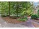 Mature trees and landscaping in the front yard along the brick sidewalk at 850 N Langdon, Pittsboro, NC 27312