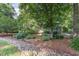 Landscaped front yard features a stone-lined drainage area and mature shade trees, plus house number '850' visible at 850 N Langdon, Pittsboro, NC 27312