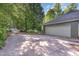 View of the two car garage with driveway approach surrounded by mature trees at 850 N Langdon, Pittsboro, NC 27312