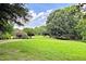 Expansive green lawn area of common space with mature landscaping and walking path at 850 N Langdon, Pittsboro, NC 27312