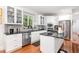 Well-lit kitchen with stainless steel appliances, custom cabinetry, and hardwood floors at 850 N Langdon, Pittsboro, NC 27312